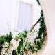 white and green floral arrangement up winding staircase railing at lotos club NYC, Franz James florist, New York wedding photographer