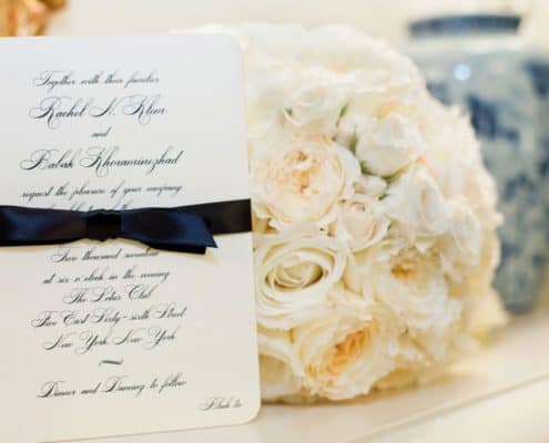 cream rose bouquet next to wedding invitation at lotos club NYC, Fleur du mois florist, New York wedding photographer.