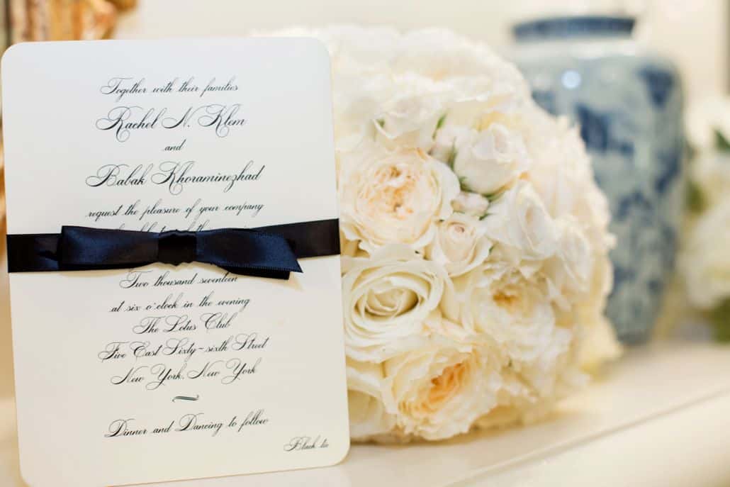 cream rose bouquet next to wedding invitation at lotos club NYC, Fleur du mois florist, New York wedding photographer.
