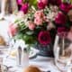 pink, fuscia, white and green rose wedding flower centerpiece in dark gray antiqued bowl, gold flatware, white linens, Karen Brown Events NYC wedding photographer.