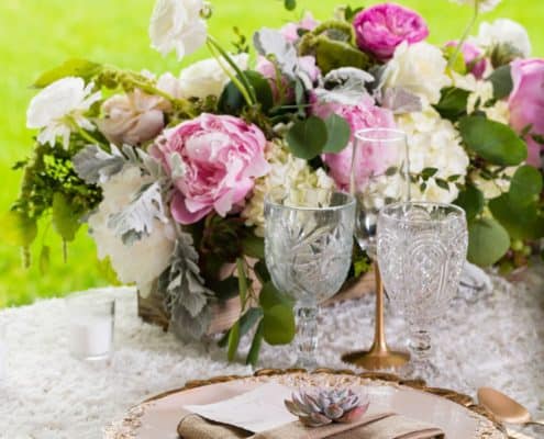 pink peony and white hydrangeas with silver and green accents floral centerpiece on ruffles tablecloth, gold charger and flatware with neutral napkin topped with succulent and ornate crystal stemware. Kristin Rockhill florist, Chauncey Center, Princeton, NJ wedding photographer.