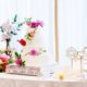 4 tier wedding cake, bright white simple frosting adorned with organically placed jewel tone flowers on silver cake stand, roses, peony, zinnia, orchids, gold accessories, white damask table cloth, Kristin Rockhill florist, Nassau Inn, Princeton, NJ wedding photographer.