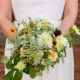 Bride with beaded lace bodice gown holds whimsical wildflower bridal bouquet, Jenn Florin Florist, Brooklyn Grange, Brooklyn Navy Yard, Brooklyn wedding photographer.