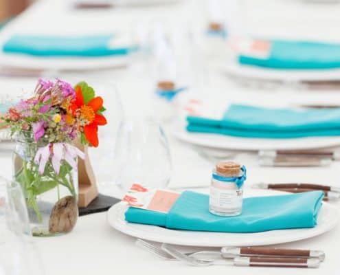 Bright wildflowers in mason jar wedding table decor, turquoise napkins, wooden handled flatware, white plates and table cloth, Jenn Florin florist, Brooklyn Grange, Brooklyn Navy Yard wedding photographer.