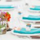 Bright wildflowers in mason jar wedding table decor, turquoise napkins, wooden handled flatware, white plates and table cloth, Jenn Florin florist, Brooklyn Grange, Brooklyn Navy Yard wedding photographer.