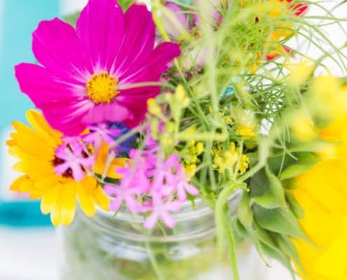 fuscia, yellow and green wildflowers in mason jar at Brooklyn Grange, Brooklyn Navy Yard wedding, Jenn Florin florist. New York wedding photographer.