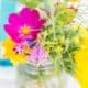 fuscia, yellow and green wildflowers in mason jar at Brooklyn Grange, Brooklyn Navy Yard wedding, Jenn Florin florist. New York wedding photographer.