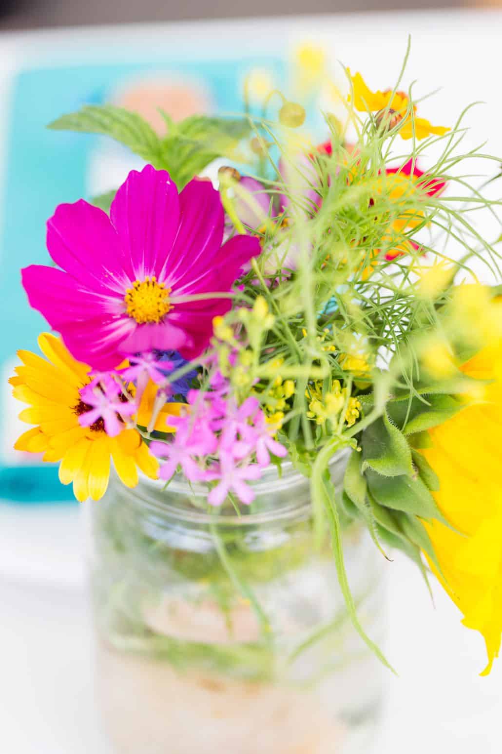 fuscia, yellow and green wildflowers in mason jar at Brooklyn Grange, Brooklyn Navy Yard wedding, Jenn Florin florist. New York wedding photographer.