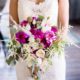 bride in lace strapless gown holds large, fuscia and white wedding bouquet with silver leaf accents, astilbe, primrose, Flower Muse flower wholesaler, Krystle De Santos wedding designer, Metropolitan Building, Long Island City, NY wedding photographer.