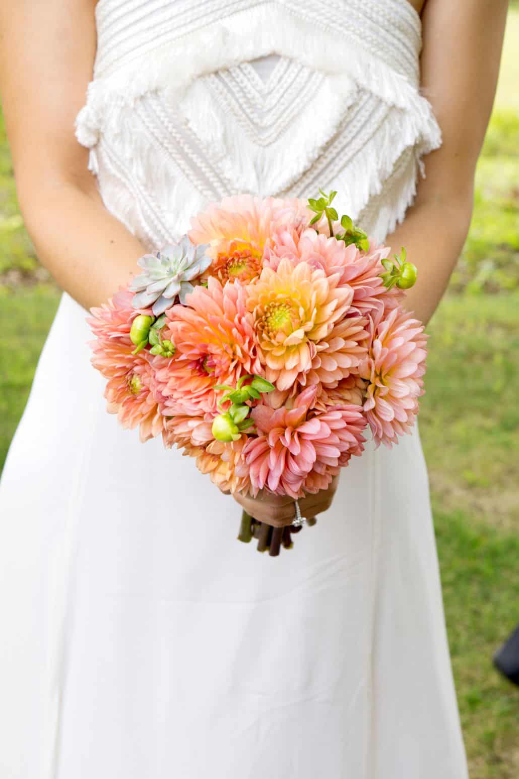 bride wearing fringed bodice wedding dress holds peach and orange wedding bouquet with succulents, Parker's Petals florist, Mohawk House, Sparta, NY wedding photographer.