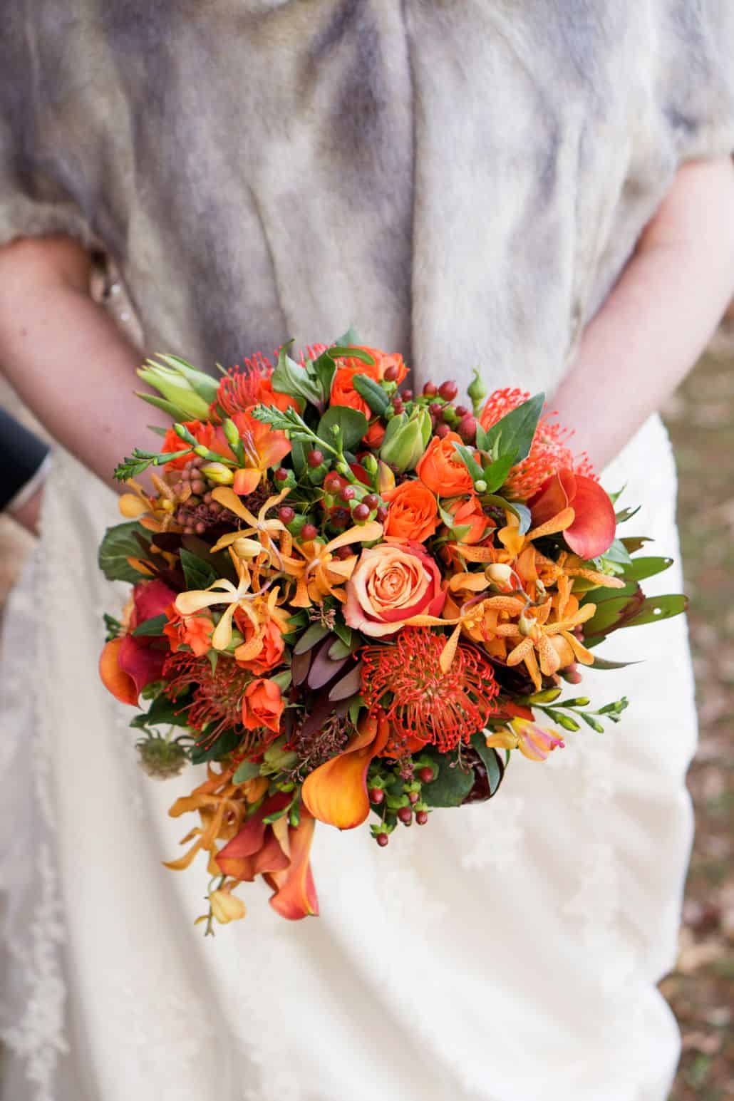 burnt orange and green wedding bouquet, roses, protea