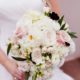 bride holds large pale pink and white wedding bouquet with dark green leaf accents, roses, zinnias, hydrangea, Viburnum florist, Cherry Valley Country Club, Skillman, NJ wedding photographer.