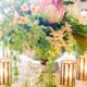 wedding table centerpiece in large silver urn, king protea flowers and hanging leaves, gold candle holders, white lace tablecloth, Viburnum florist, Nassau Inn, Princeton, NJ wedding photographer.
