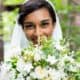 bride smiles looking over green and white wedding bouquet. Wildflowers of Princeton Junction florist, Mercer Oaks Country Club, Princeton Junction, NJ wedding photographer.