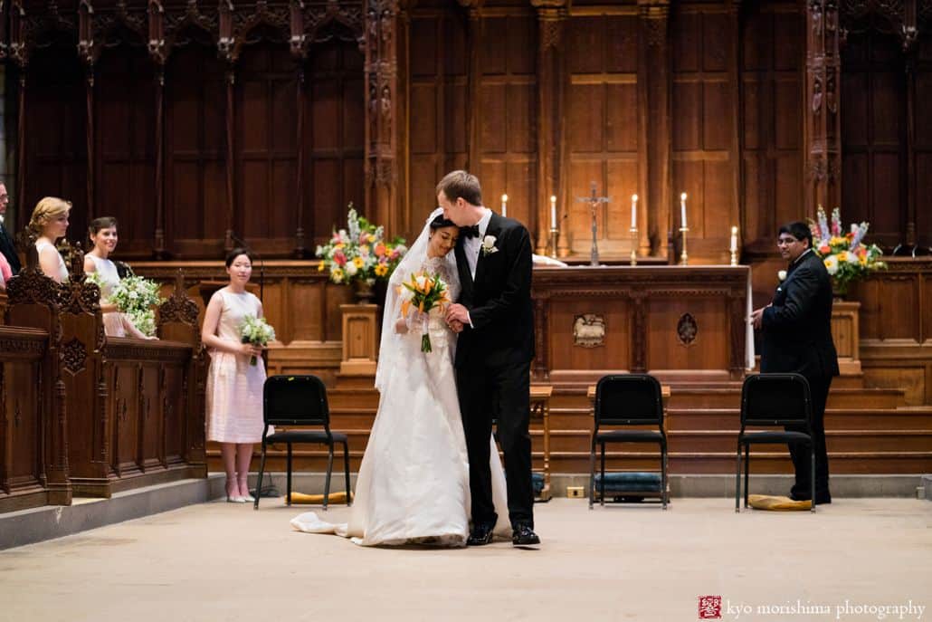 Bride and groom share an intimate moment just after Catholic wedding mass at Princeton University chapel.