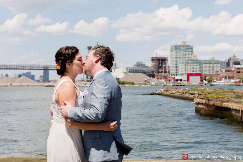 First look kiss along the waterfront at Brooklyn Grange wedding at the Navy Yard