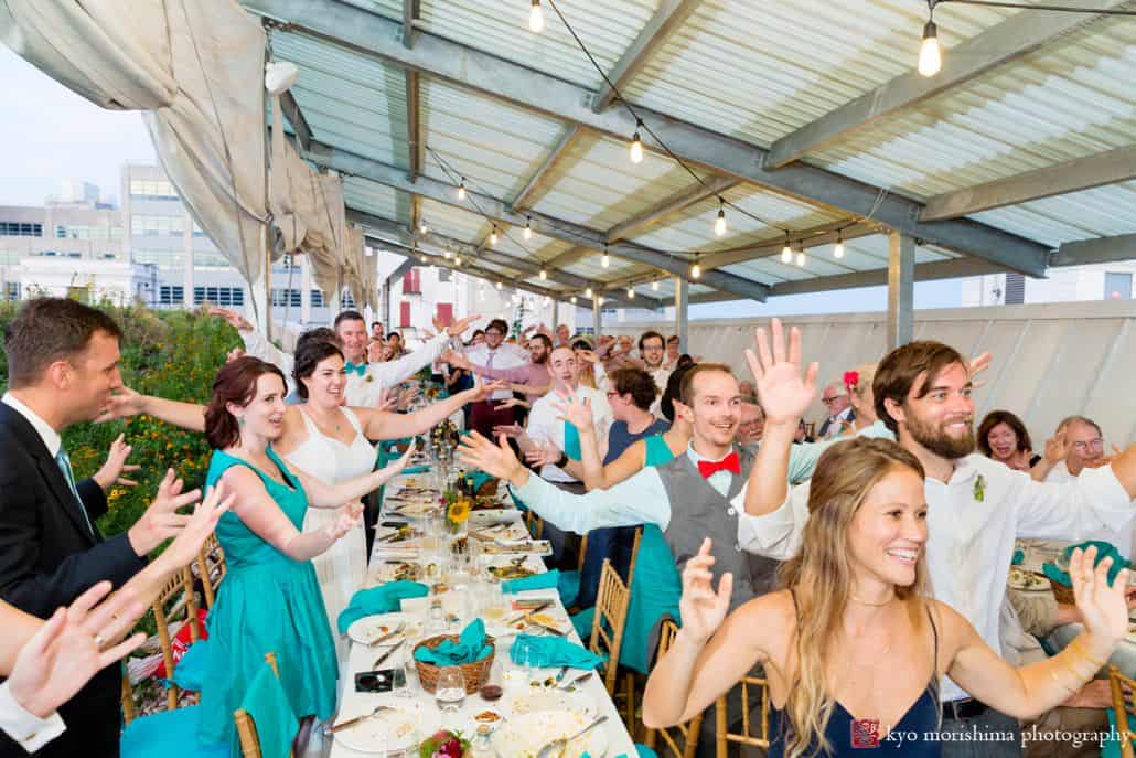 Guests offer toast at Brooklyn Grange wedding reception