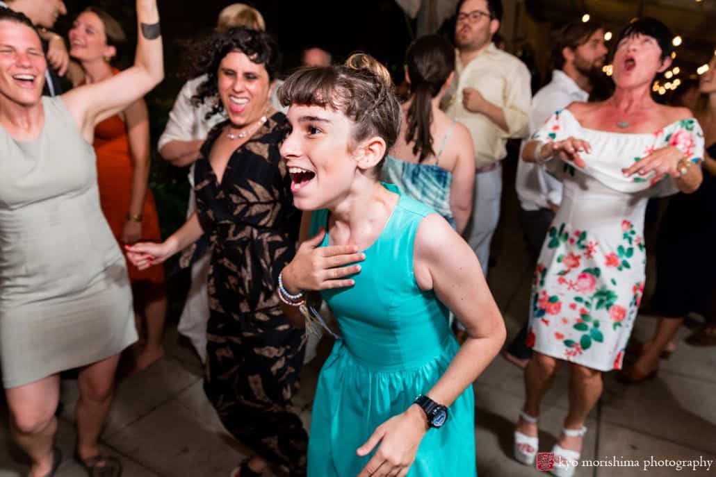 Bridesmaid wearing teal dress parties at Brooklyn Grange wedding celebration