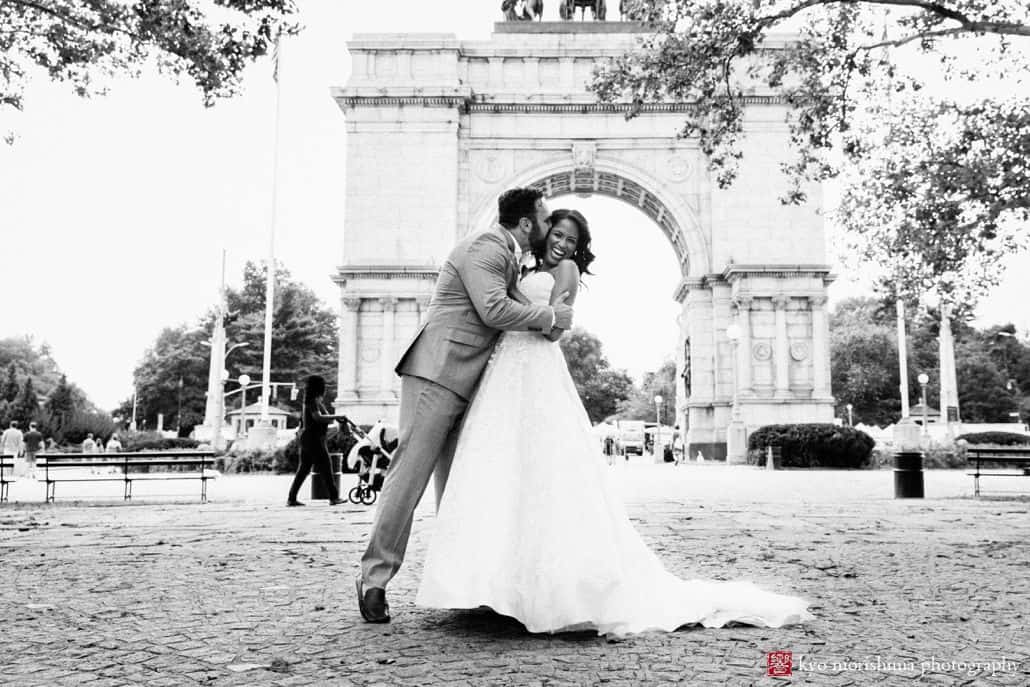 Prospect Park wedding pictures: bride and groom kiss in front of Grand Army Plaza park entrance
