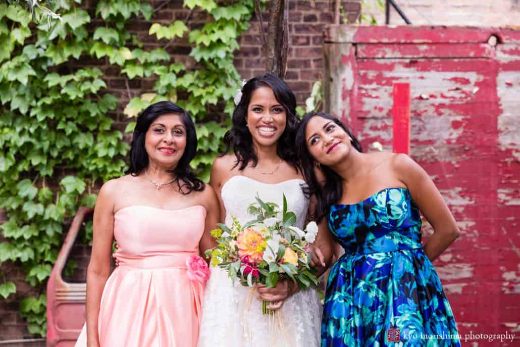 Cute wedding picture: bride with mom and sister leaning her head on her shoulder at Electric Anvil Tattoo in Brooklyn