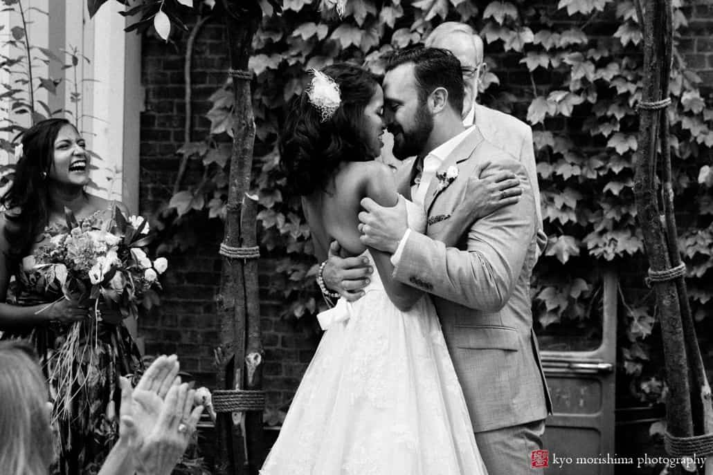 Brooklyn wedding photographer: candid shot of bride and groom at the end of their wedding ceremony at Electric Anvil Tattoo in Crown HeightsBrooklyn wedding photographer: candid shot of bride and groom at the end of their wedding ceremony at Electric Anvil Tattoo in Crown Heights