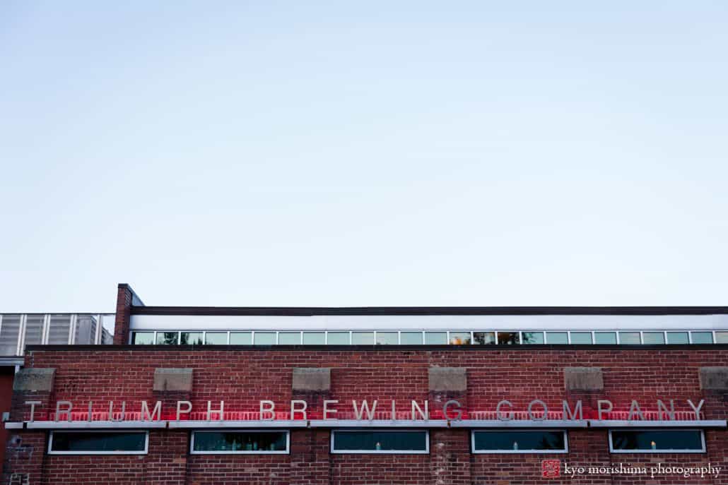 Triumph Brewing Company building sign, red brick, red neon lights, New Hope, PA intimate wedding photographer.