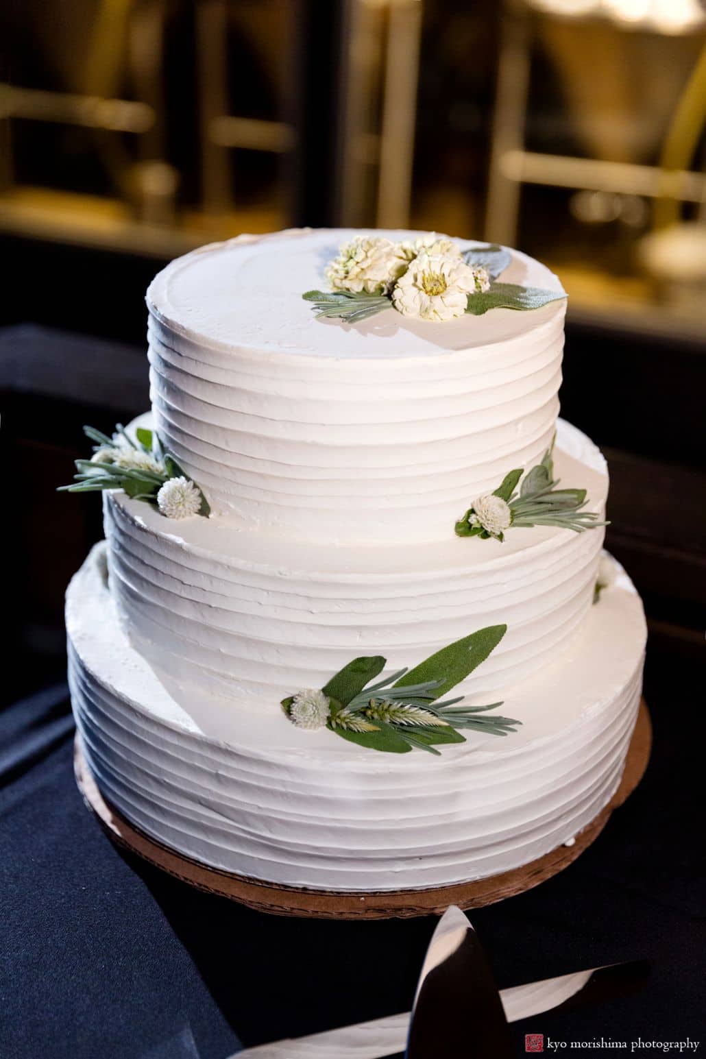 Simple and elegant 3 tier wedding cake with small white flowers and sage leaves, Factory Girl Bake Shop, Triumph Brewing Company, New Hope, PA wedding photographer.