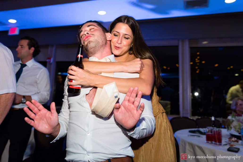 Wedding guests sing and dance at wedding reception, man's shirt has come unbuttoned and tie flies through the air, Woodloch Pines wedding photographer, cute wedding pictures.