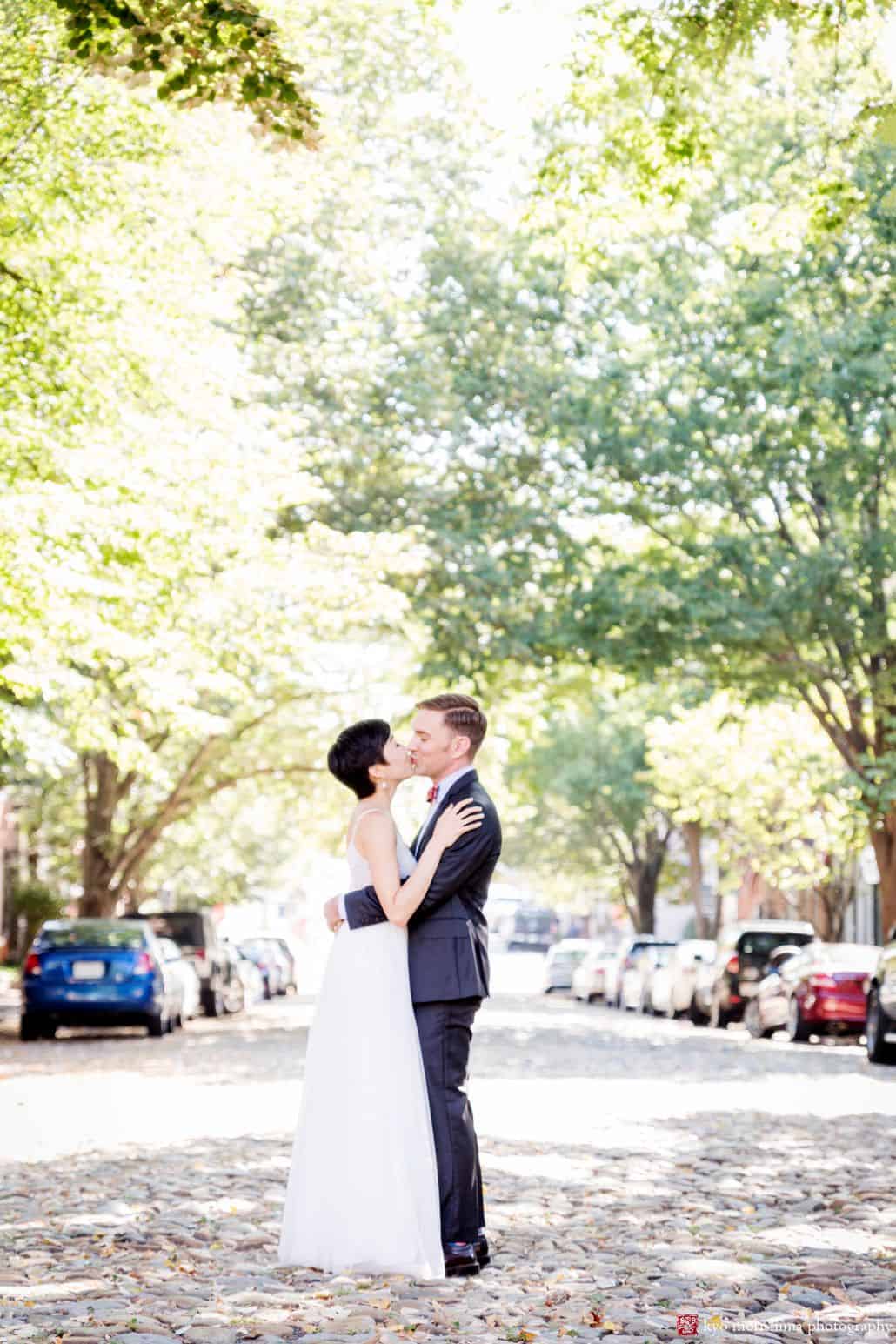 Bride and groom kiss on September morning before their wedding in Old Town Alexandria, by DC wedding photographer Kyo Morishima