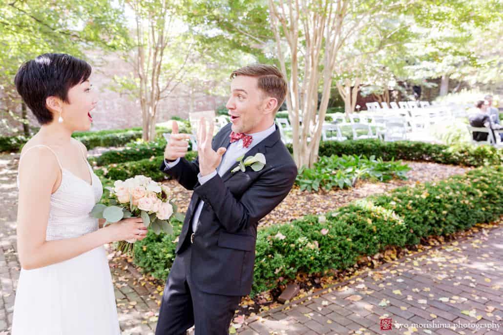 Fun wedding photo as groom shows bride how crazy it is that he's wearing a wedding ring nowFun wedding photo as groom shows bride how crazy it is that he's wearing a wedding ring now