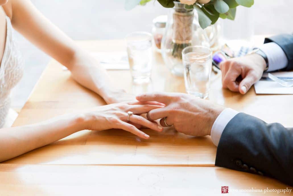 Bride and groom hold hands at restaurant in Old Town Alexandria