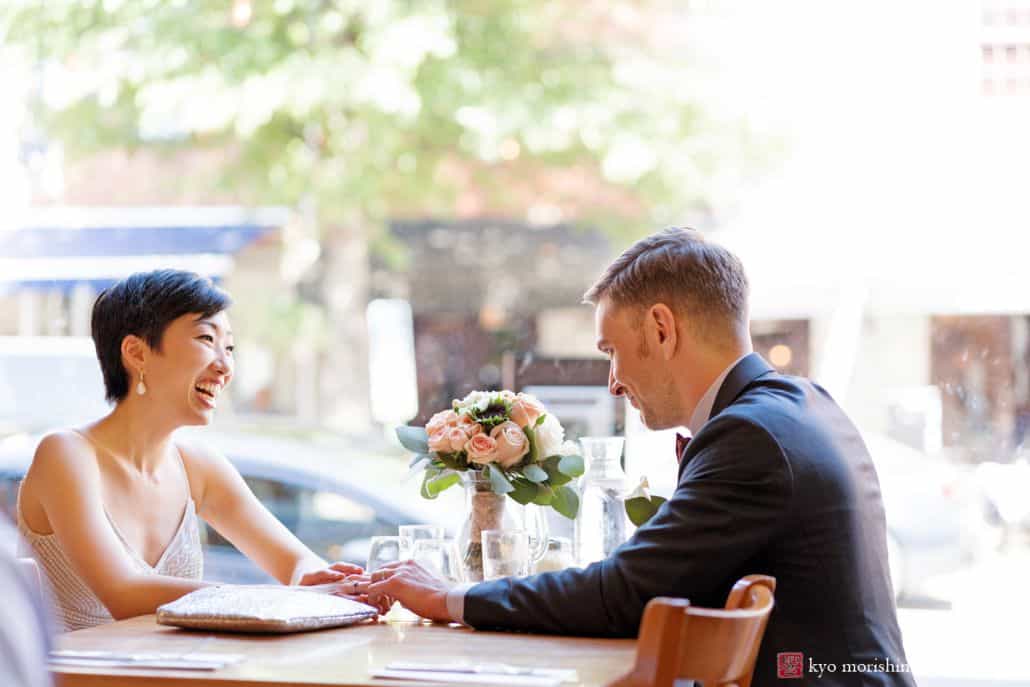 Bride and groom relax at pizza joint in Old Town Alexandria before going to their wedding reception; candid photo by DC photographer Kyo Morishima