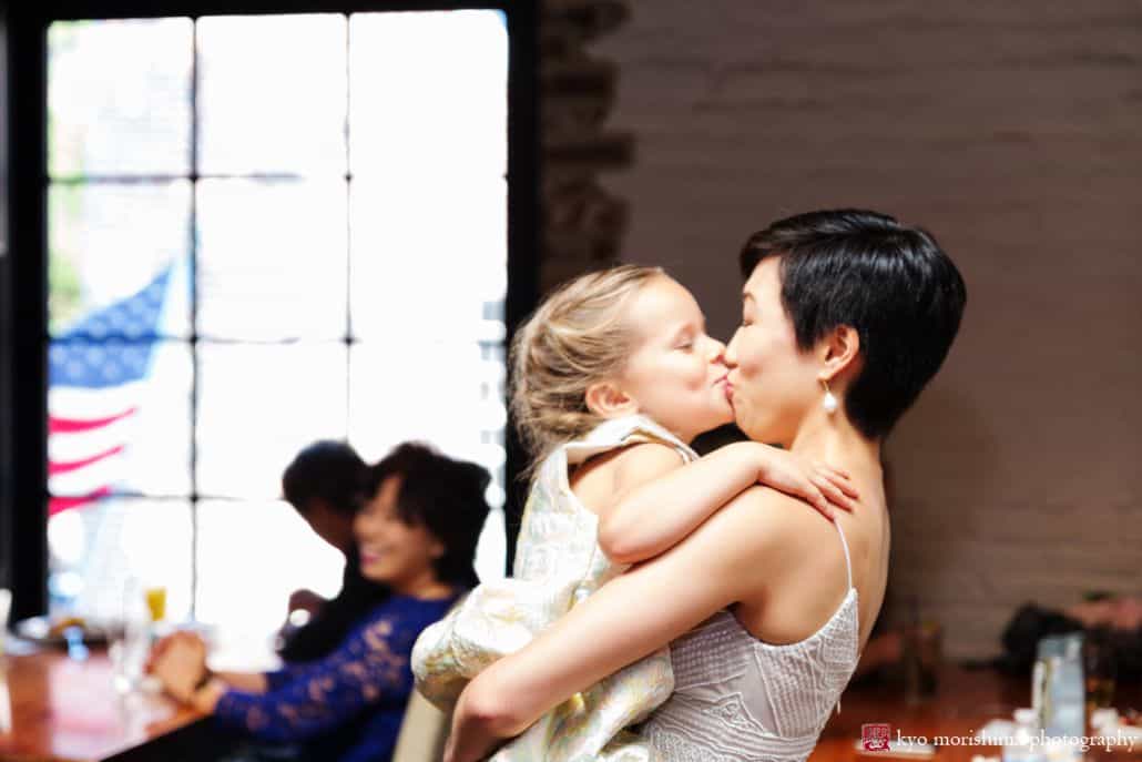 Little girl kisses Asian bride at multicultural wedding at Virtue Feed and Grain in Old Town Alexandria