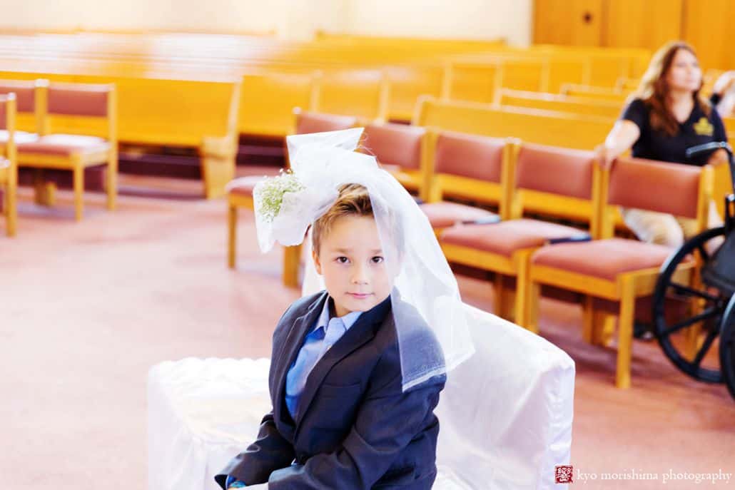 Young boy clowns for camera at St. Magdalen Church wedding in Flemington NJ