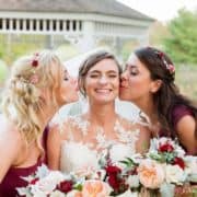 Wedding poses examples: bridesmaids kiss bride in front of gazebo at Chauncey Hotel and Laurie House Garden Pavilion wedding, Princeton, NJ