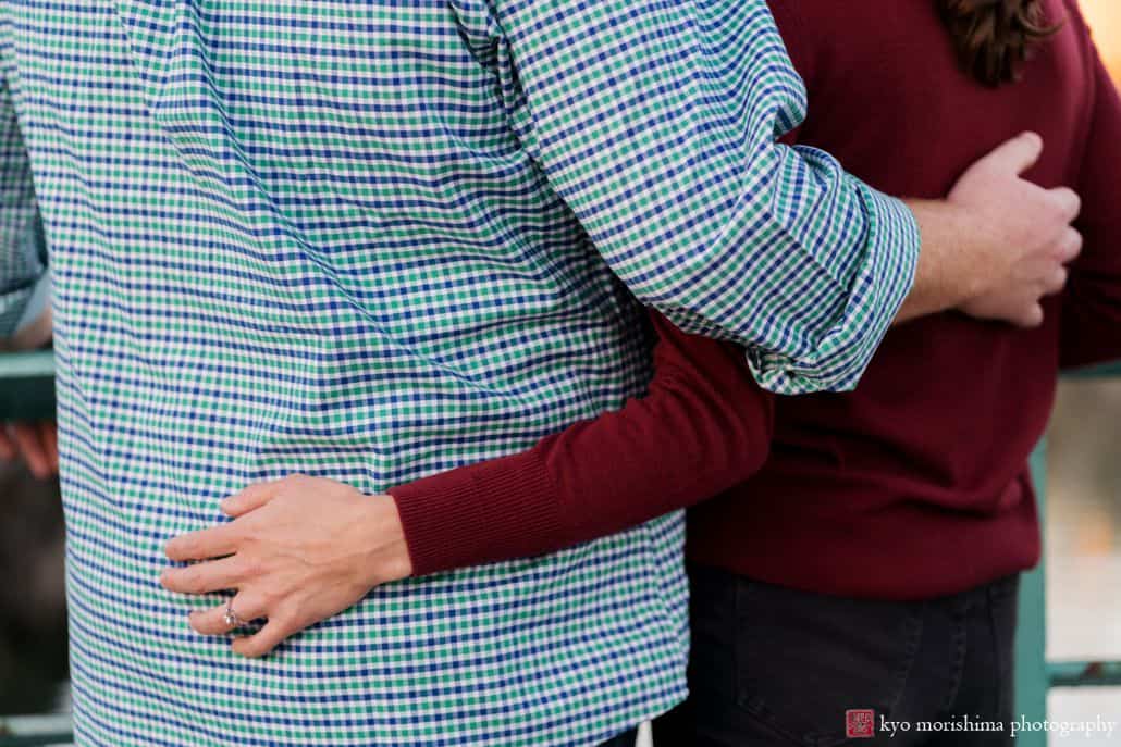 Engagement picture detail of couple with hands on each other's backs