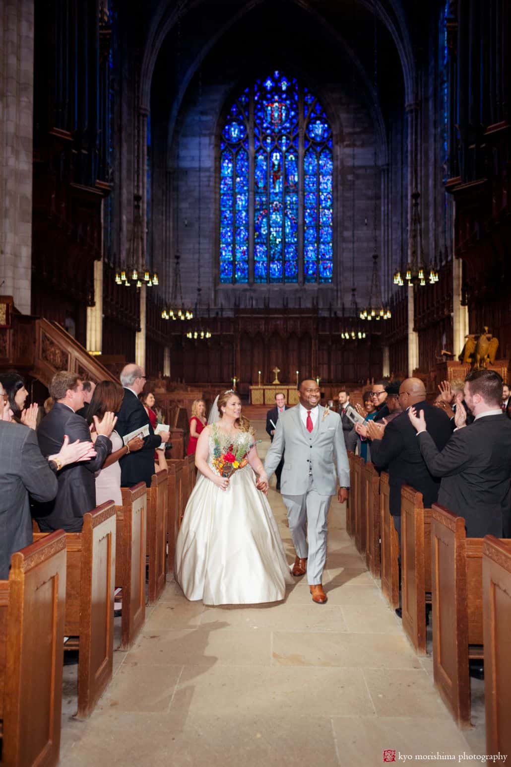 Bride and groom depart Princeton University chapel wedding, holding hands