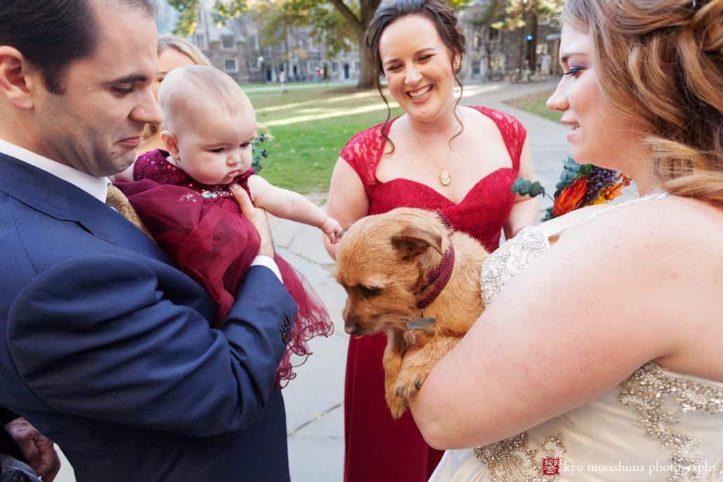 Baby and dog greet each other outside after Princeton University chapel wedding in October