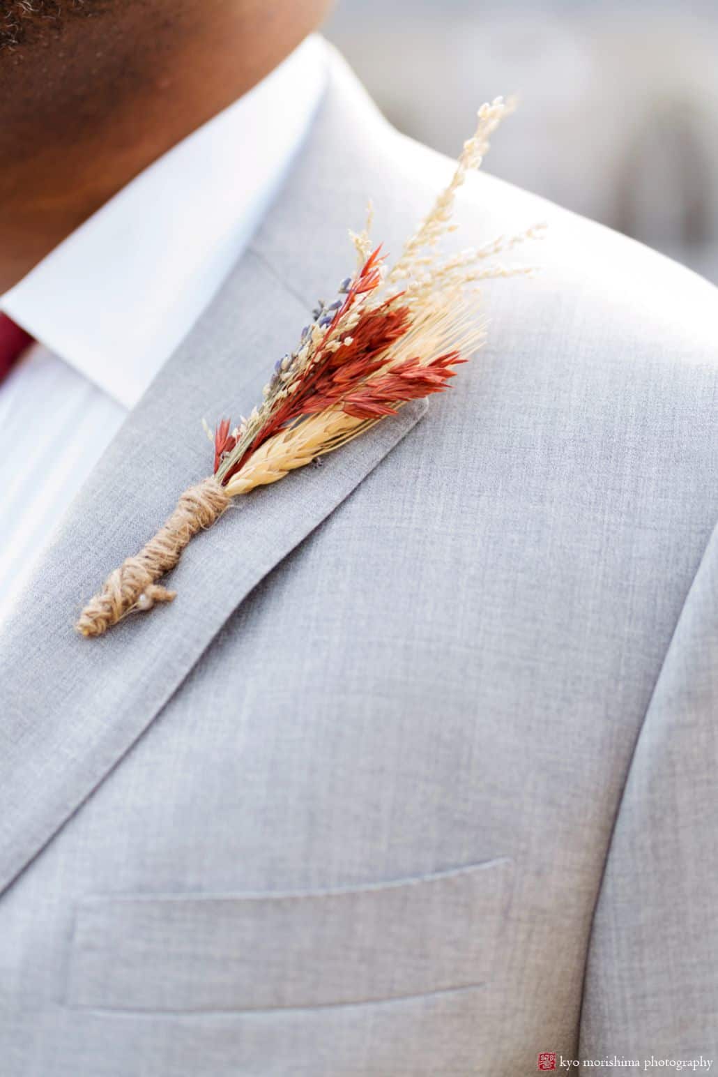 Fall grass wedding boutonniere on light grey suit