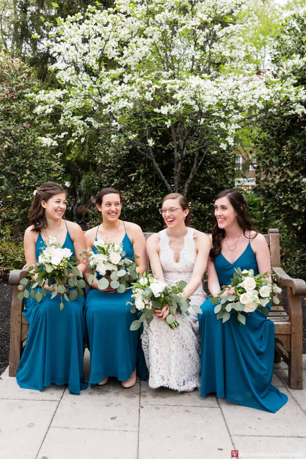 Bridesmaids wearing turquoise Brideside; bride wears BHLDN; all holding bouquets by Bloominous