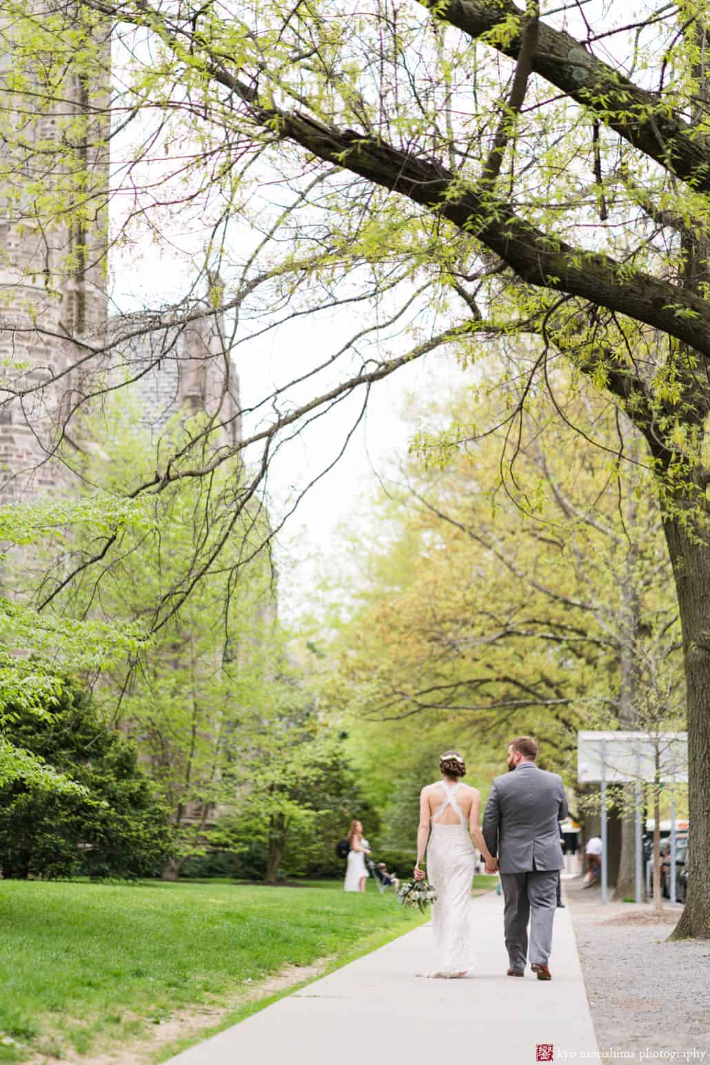 Bride and groom walk down Nassau Street in Princeton; bride wears BHLDN and groom wears Indochino