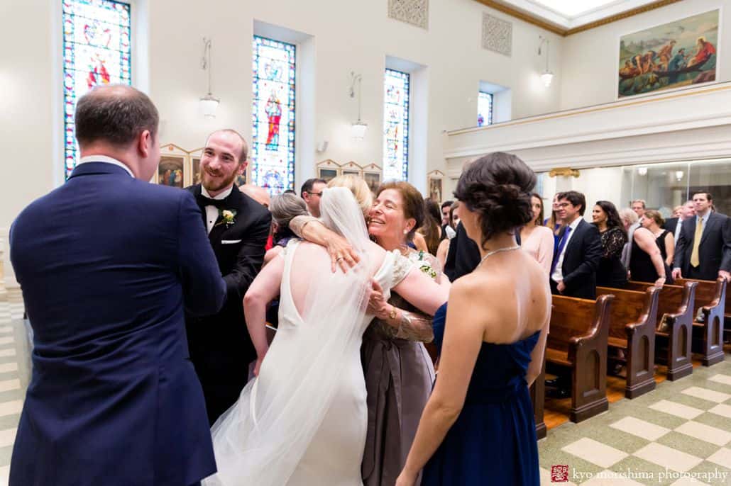 Kisses and hugs at the end of wedding ceremony at St. Peter's, a catholic church in the financial district in NYC