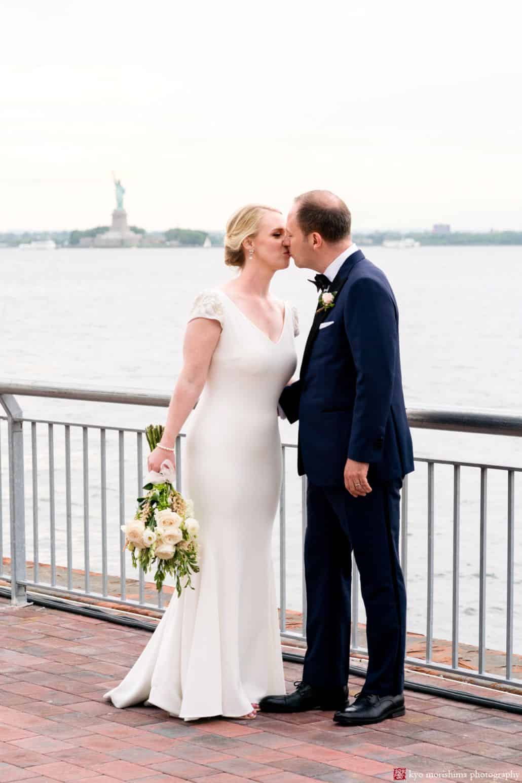 Bride and groom portrait with Statue of Liberty in background -- the Liberty Warehouse wedding venue in Red Hook has some of the best views of any NYC venue