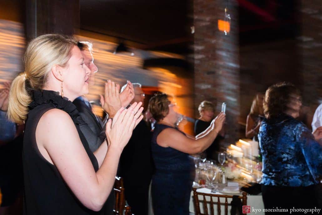 Documentary wedding photographer NYC: guests applaud during first dance at Liberty Warehouse wedding
