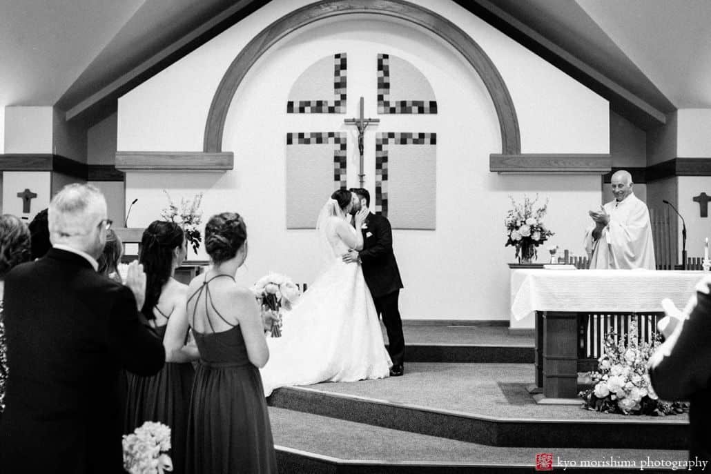 Bride and groom kiss at wedding ceremony at St. James in Pennington black and white Late Spring Mercer County Boathouse Princeton NJ Wedding 