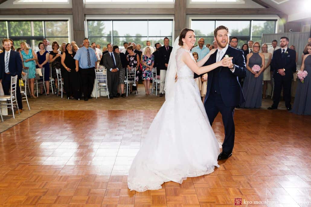 bride and groom dancing on dance floor at wedding looking at guests candid first dance picture smiling central NJ photographer Late Spring Mercer County Boathouse Princeton NJ Wedding
