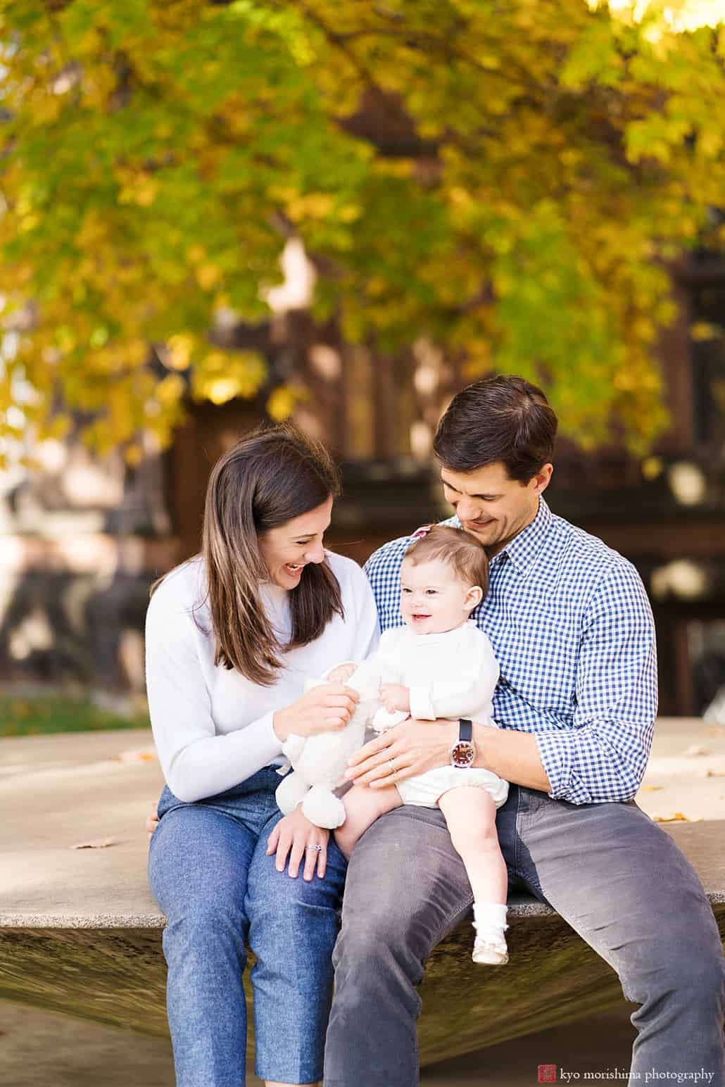Mom and Dad play with baby on Princeton campus: professional family portrait photography in New Jersey