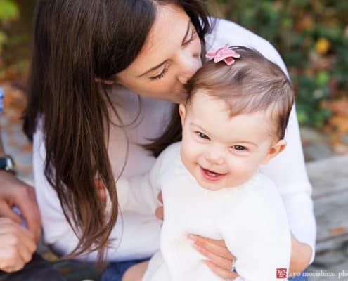 Mom kisses baby during fun, candid fall family portrait session in Princeton, NJ