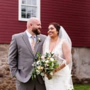 Candid wedding photographer NJ: relaxed portrait in front of the red barn at Glenmoore Farm in Hopewell NJ