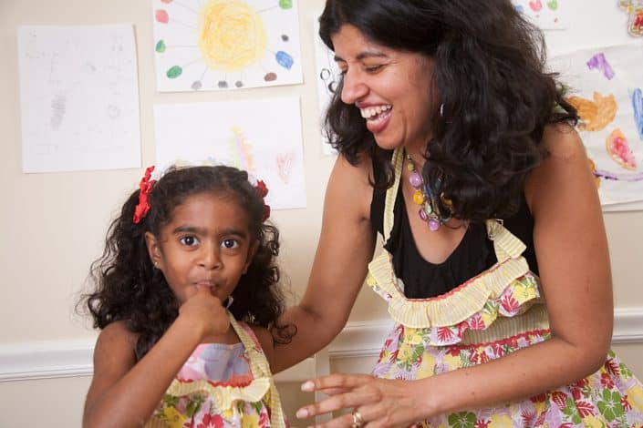 Mother and daughter baking together in a relaxed family photo shoot. NYC child and family photography.